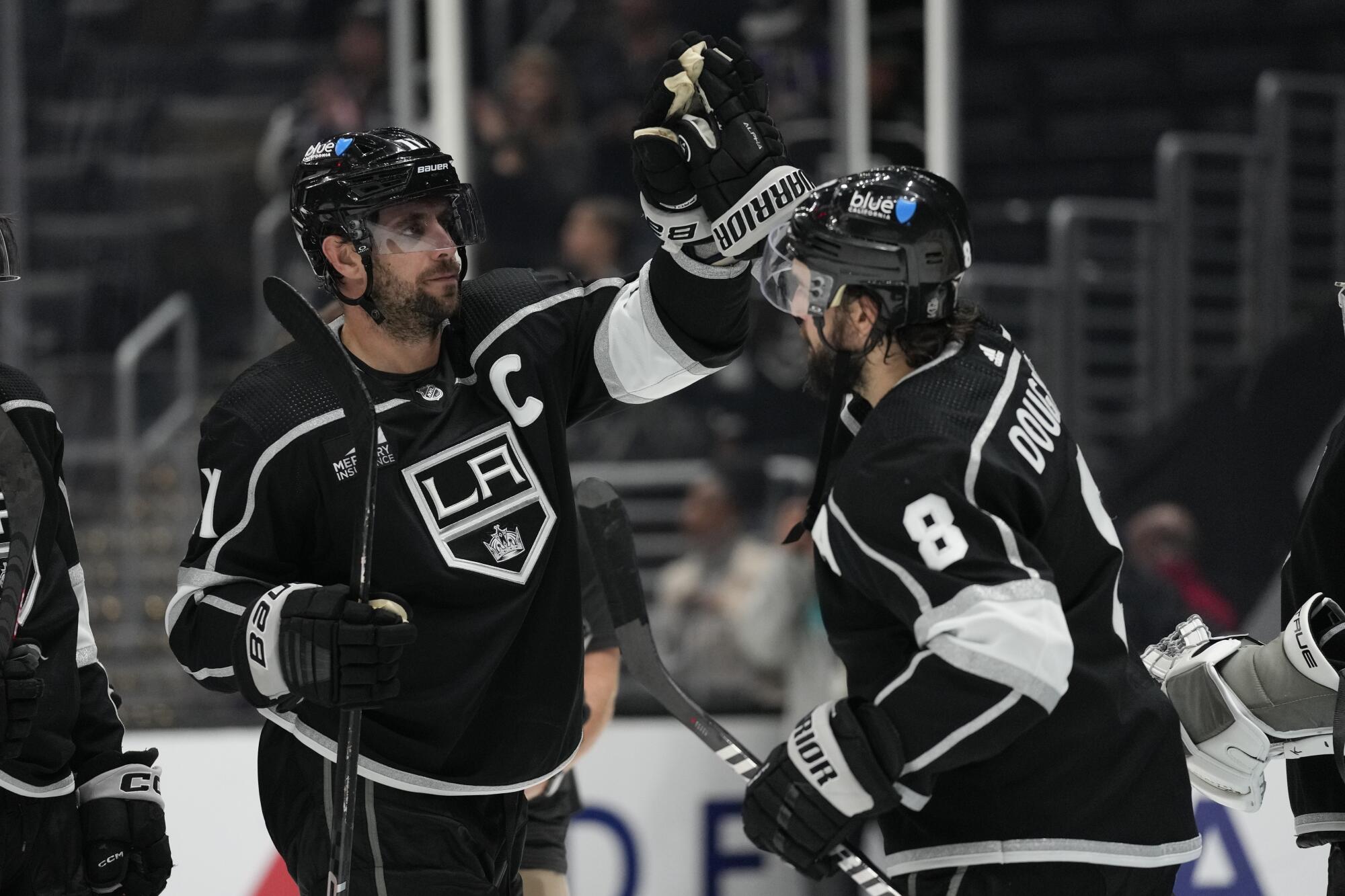 Kings captain Anze Kopitar celebrates with defenseman Drew Doughty after a 6-3 win over the Arizona Coyotes on Oct. 24.