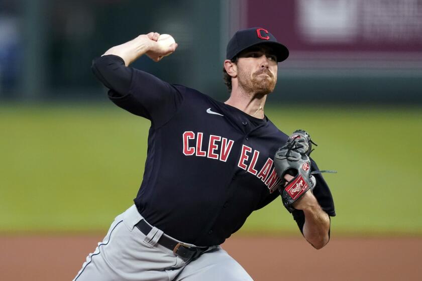 FILE - In this Aug. 31, 2020, file photo, Cleveland Indians starting pitcher Shane Bieber throws during the first inning of the team's baseball game against the Kansas City Royals in Kansas City, Mo. Bieber won the AL Cy Young Award on Wednesday night, Nov. 11, 2020. (AP Photo/Charlie Riedel, File)
