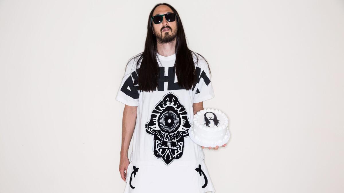 Grammy-nominated music producer, DJ and EDM musician Steve Aoki, seen here in 2014, has been known for "caking" fans at his packed shows. Now he's diving deep into fashion.