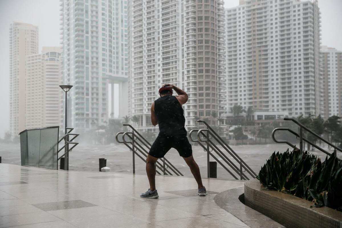 A man stands firm against the wind by the Miami River as Hurricane Irma passes through on Sept. 10, 2017.