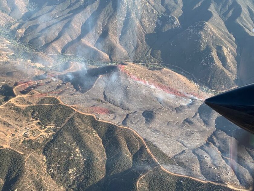 A fire burned Tuesday afternoon on a ridge east of Dehesa Road and Sloan Canyon Road, south of Sycuan Casino Resort and west of Loveland Reservoir.