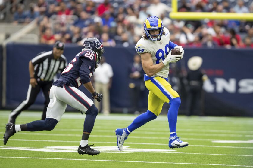 Tight end (89) Tyler Higbee of the Los Angeles Rams catches a pass and runs against the Houston Texans in an NFL football game, Sunday, Oct. 31, 2021, in Houston, Texas. The Rams won 38-22. (AP Photo/Jeff Lewis)