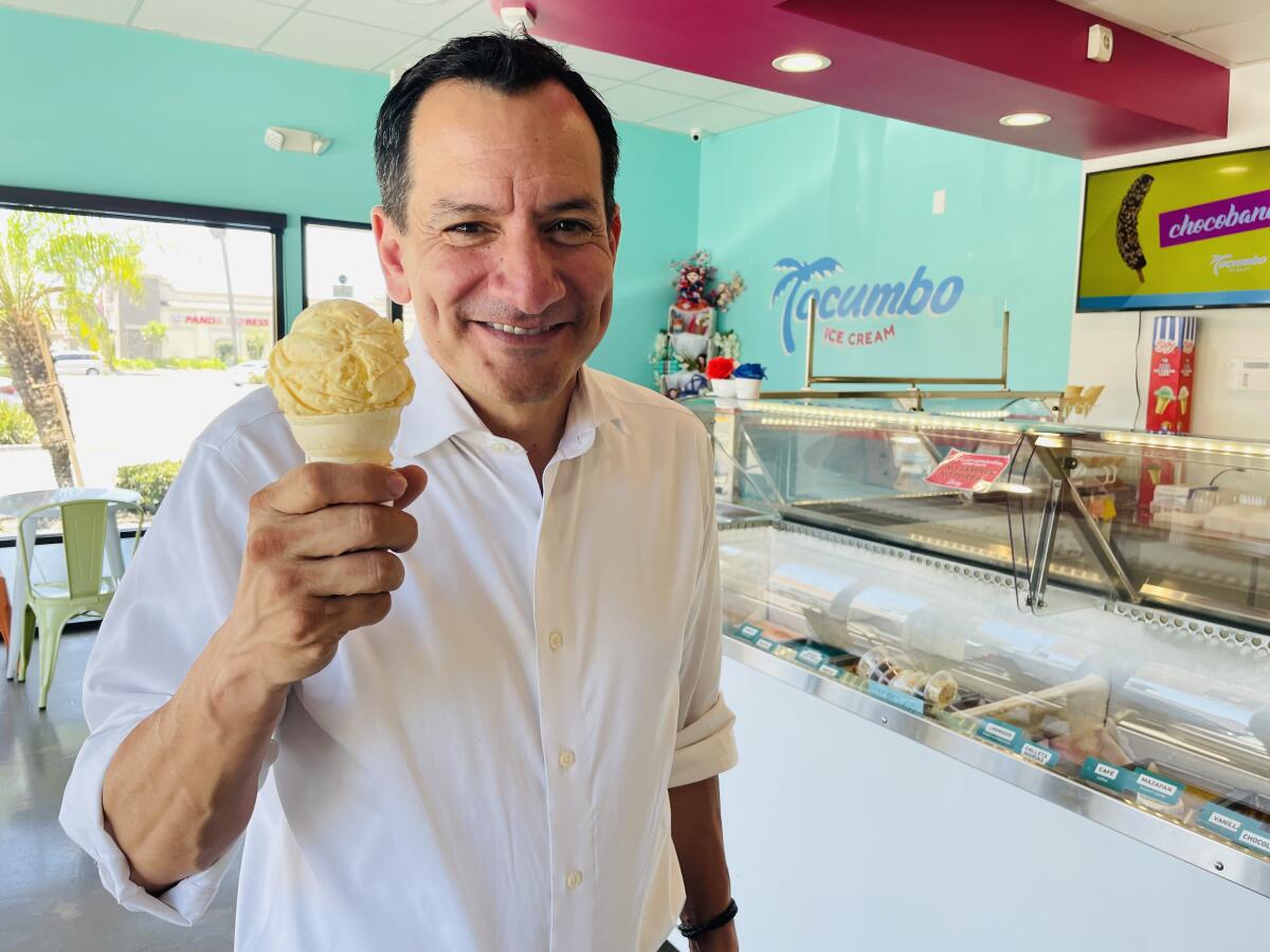 A man holds up a cone.