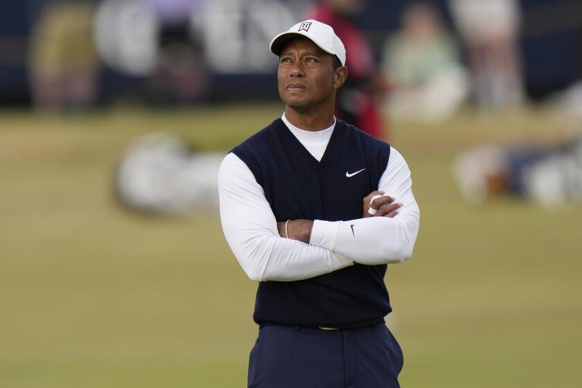 Tiger Woods of the US waits to play on the 11th tee during the first round of the British Open.
