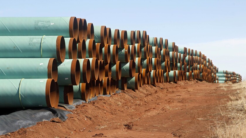 Miles of pipe ready to become part of the Keystone pipeline are stacked in a field near Cushing, Okla.
