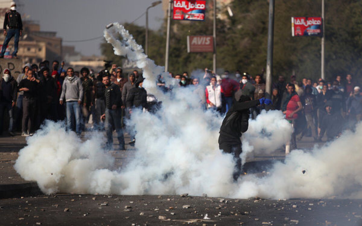 Egyptian protesters face off against riot police, unseen, near Tahrir Square in Cairo on Tuesday.