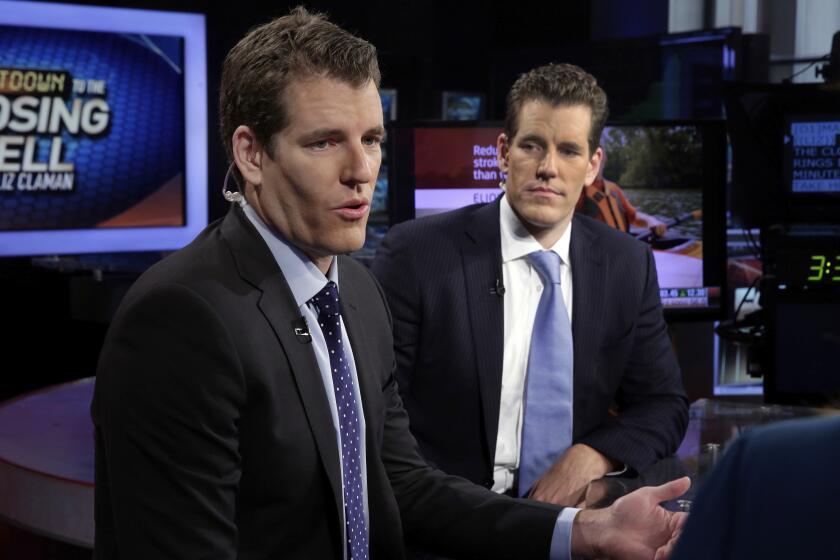 FILE - In this Thursday, Oct. 8, 2015 file photo, Tyler Winklevoss, left, and Cameron Winklevoss, founders of Gemini Trust Co., appear on the Fox Business Network, in New York. Tyler and Cameron Winklevoss are once again seeing Mark Zuckerberg steal their thunder with Facebook’s Libra digital currency. (AP Photo/Richard Drew, File)