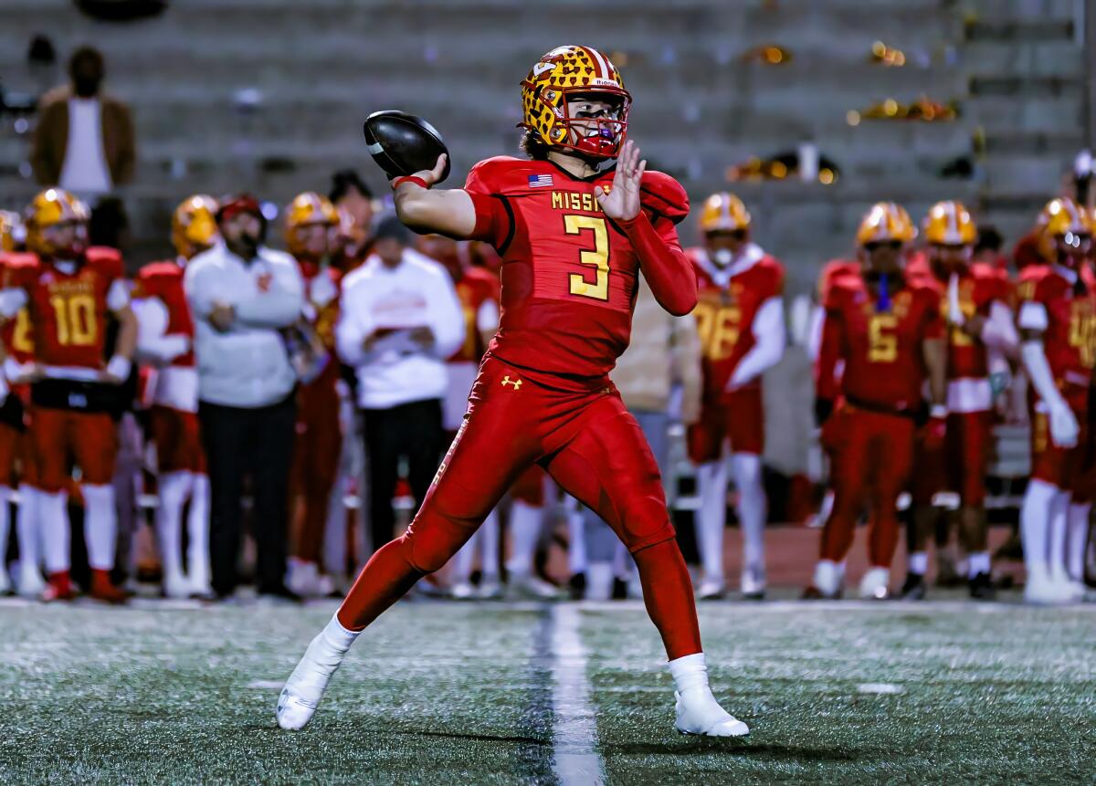 This week's prime highschool soccer playoff video games 1 Luke Fahey of Mission Viejo sets up in the pocket to throw a pass.