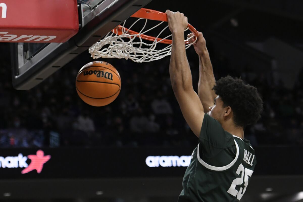 Michigan State's Malik Hall (25) dunks during the first half of an NCAA college basketball game against Northwestern, Sunday, Jan. 2, 2022, in Chicago. (AP Photo/Paul Beaty)