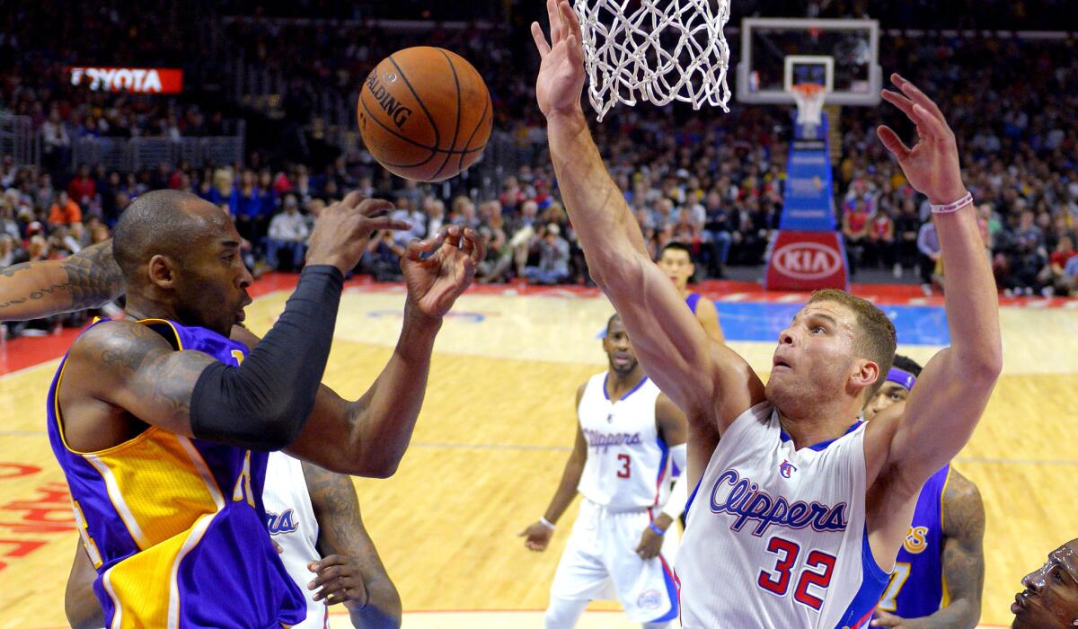 Lakers guard Kobe Bryant flips a pass to a teammate in the lane as Clippers forward Blake Griffin defends during their game Wednesday night.
