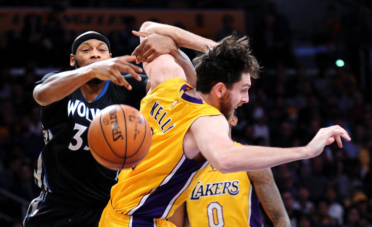 Lakers forward Ryan Kelly and Timberwolves forward Adreian Payne battle for a rebound in the first half Wednesday night at Staples Center.