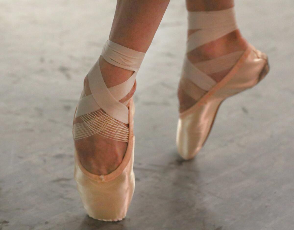 A dancer on pointe in pink pointe shoes