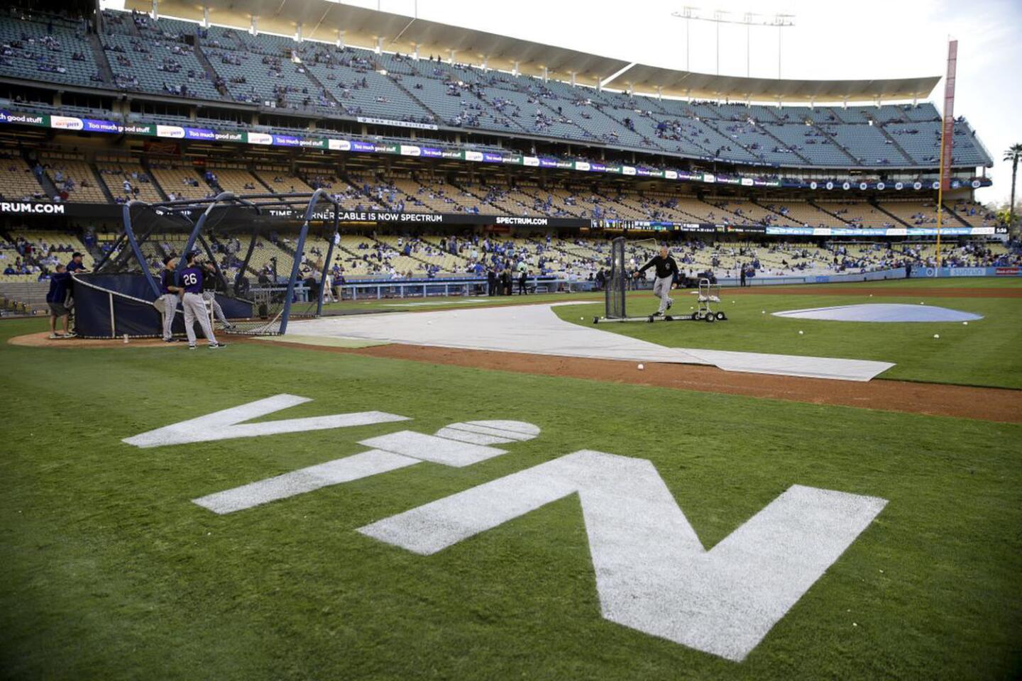 Hall of Fame Los Angeles Dodgers broadcaster Vin Scully's initials are painted on the field at Dodger Stadium before the team's baseball game against the Colorado Rockies, Friday, Sept. 23, 2016, in Los Angeles. Scully's final game at the stadium will be Sunday.