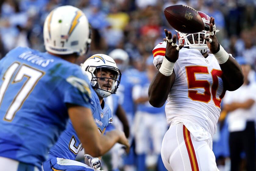 Chiefs linebacker Justin Houston (50) intercepts a pass thrown by Chargers quarterback Philip Rivers (17) in the second half. Houston returned it for a touchdown.