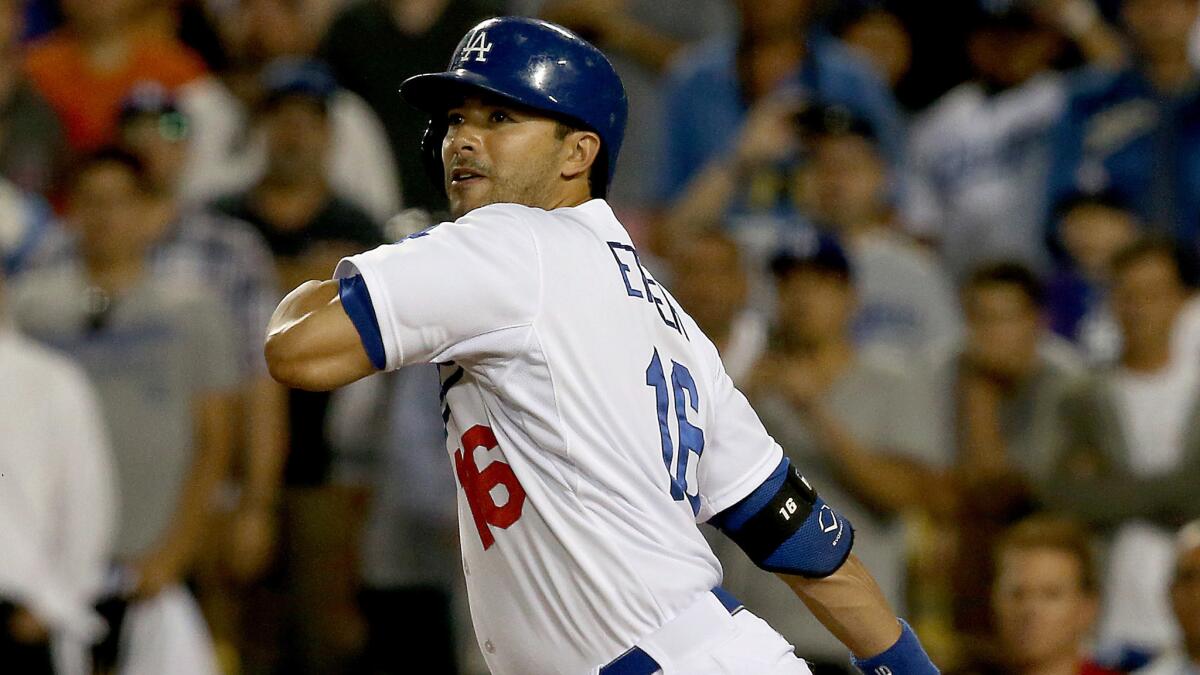 Dodgers pinch-hitter Andre Ethier hits a bouncer to third base, allowing teammate Juan Uribe (not pictured) to score the winning run on a throwing error in the ninth inning of the Dodgers' 5-4 win over the Angels on Tuesday.