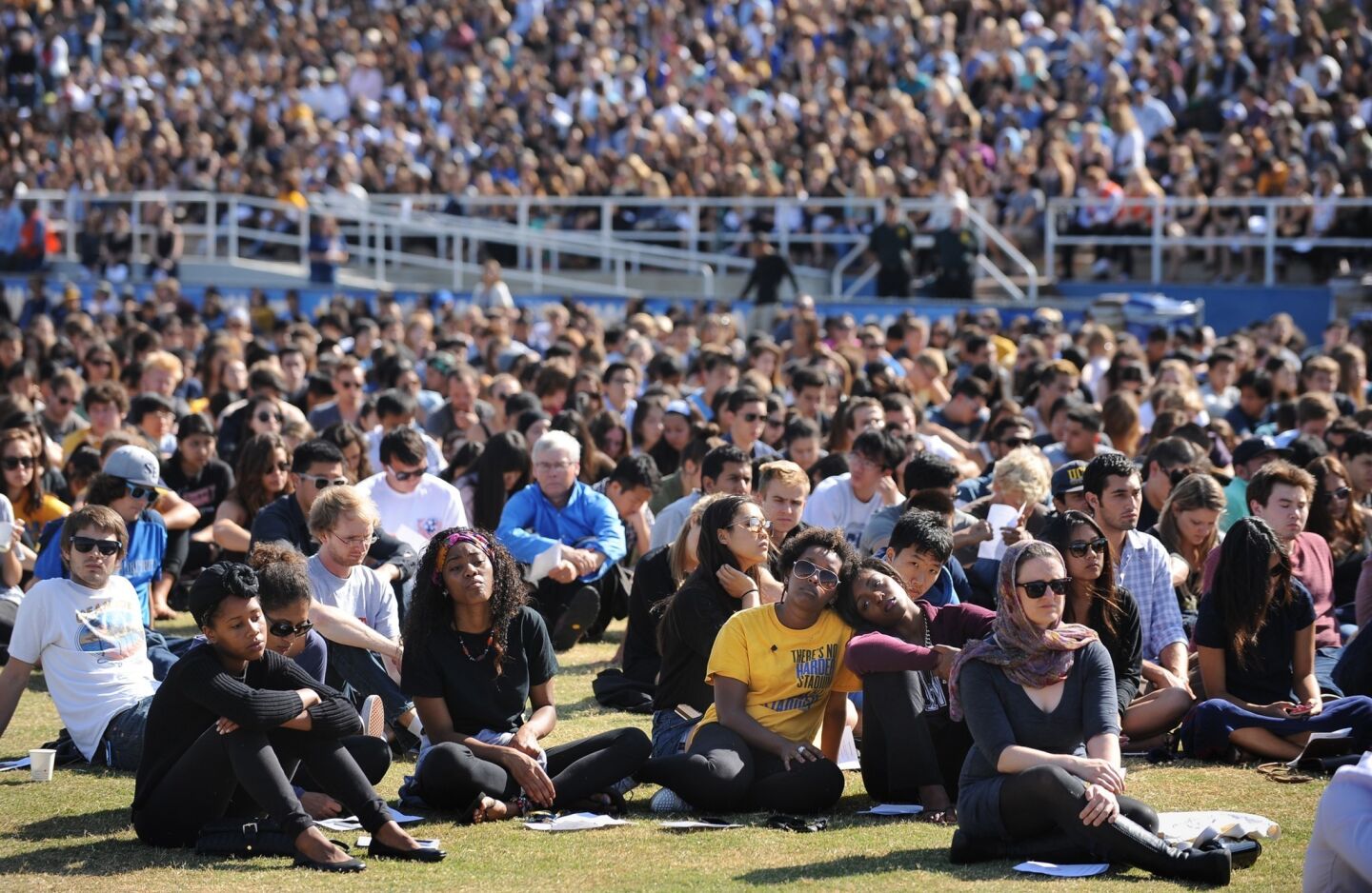 Students listen to a memorial service at UCSB for six students slain Friday in Isla Vista.