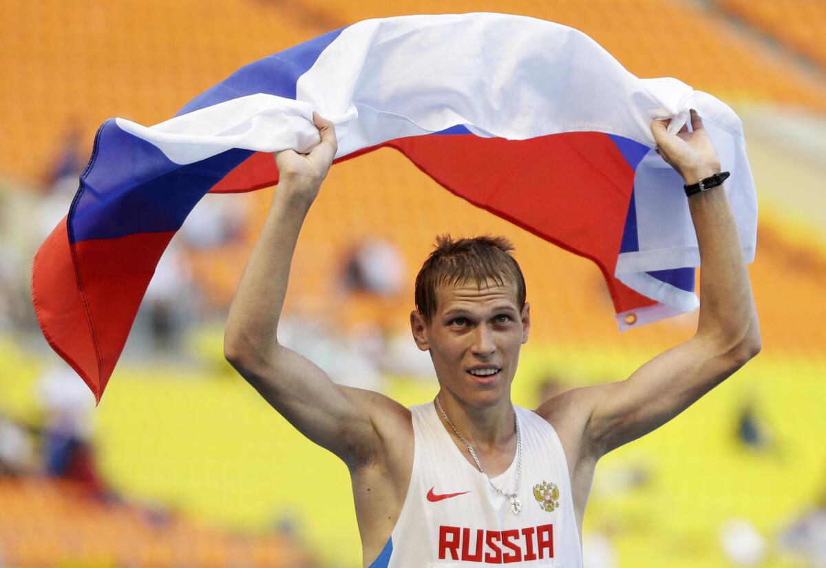 Russian race walker Mikhail Ryzhov celebrates after winning silver in the men's 50-kilometer race walk at the 2013 World Athletics Championships. Ryzhov is one of a number of atheles coached by Viktor Chegin who have faced bans for doping.