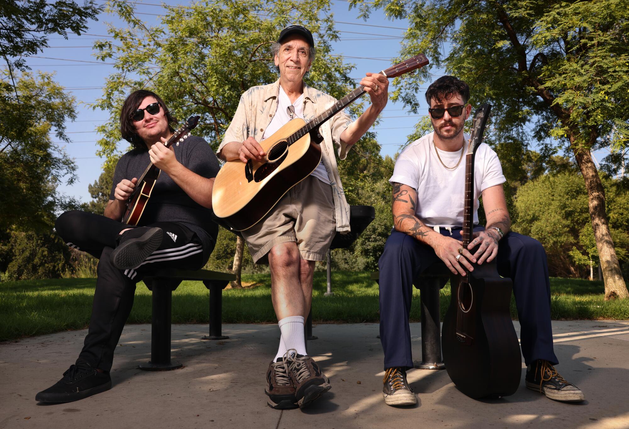 Friends Justin Beverly, 26, Jose Bautista, 73, and Nicholas Baraban, 33, hang out at Johnny Carson Park in Burbank.