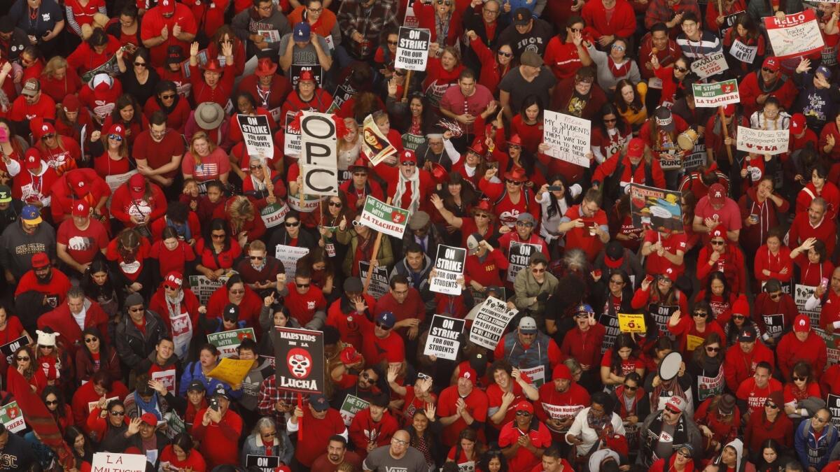 Thousands of United Teachers Los Angeles members and supporters rally on the fifth day of the teachers' strike in downtown L.A.'s Grand Park on Friday.