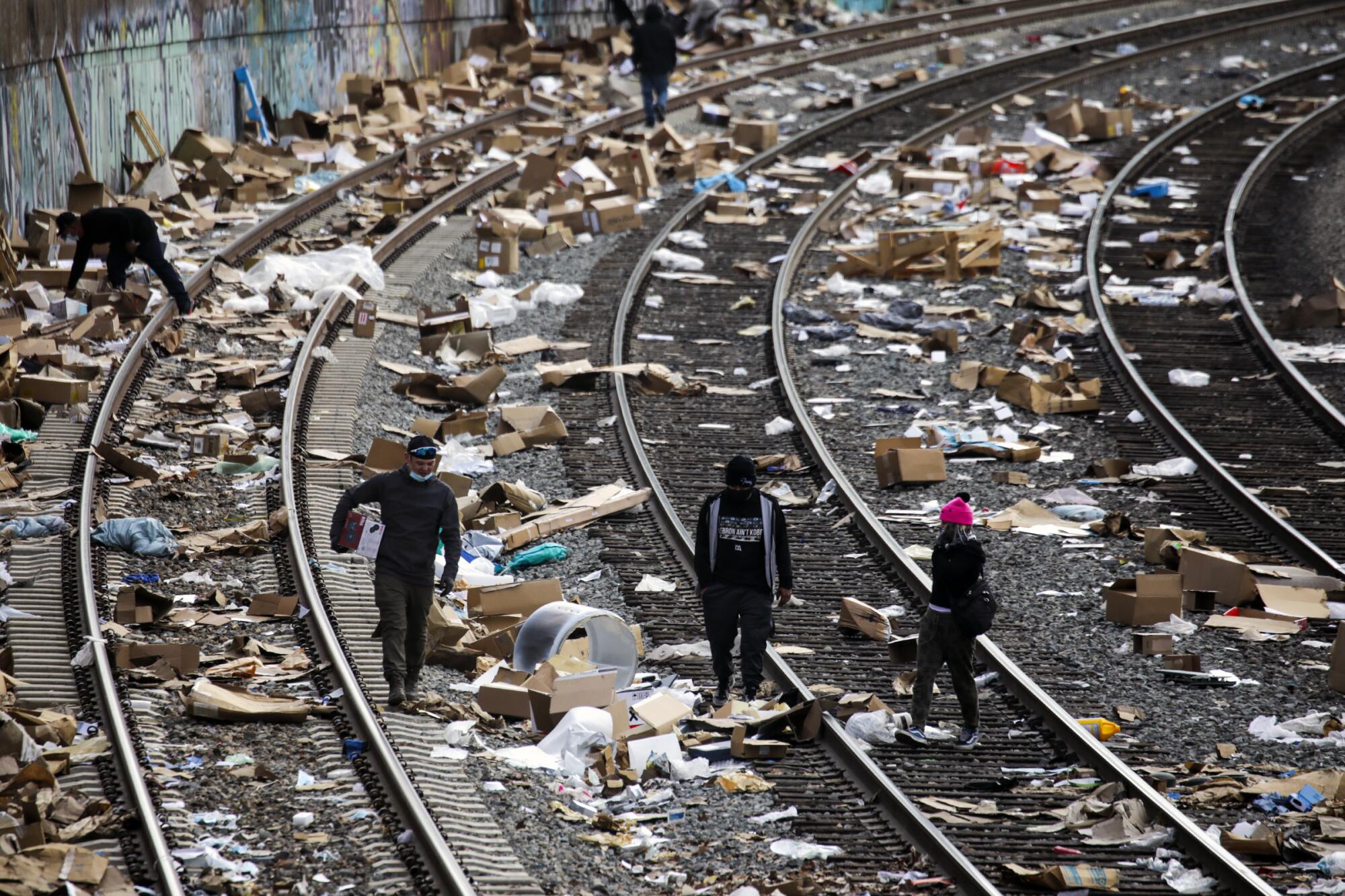People rummage through boxes left along Union Pacific train tracks near downtown Los Angeles.