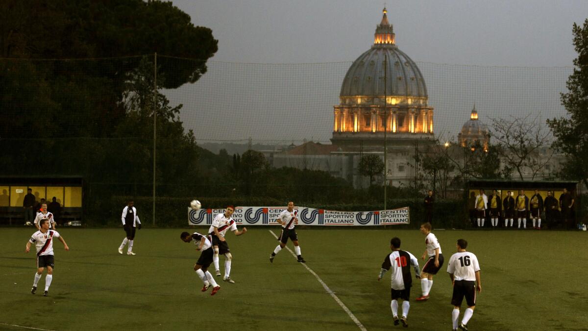 Players on the Collegio San Paolo and North American Martyrs teams play in a Clericus Cup soccer match on a hill overlooking St. Peter's Basilica in Rome in March 2013. The Vatican-supported tournament features 16 teams this year.