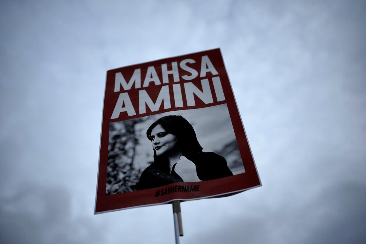 A placard with a picture of Iranian woman Mahsa Amini.
