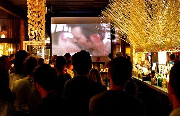 A crowd at O-Bar in West Hollywood screens trailers of short films by gay artists as part of an effort by safe-sex advocates and educators to reach young people. Nationally, rates of HIV and AIDS have been rising.