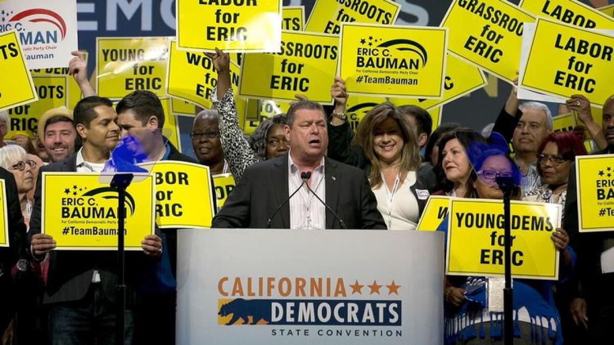 Eric Bauman, center, addresses the California Democratic Party's annual convention in May.