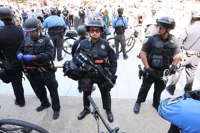 LOS ANGELES, CA MAY 6, 2024 - UC Police stand outside Dodd Hall as more protests emerged at UCLA on Monday, May 6, 2024, with police arresting multiple people who gathered in a campus parking garage. (Brian van der Brug / Los Angeles Times)