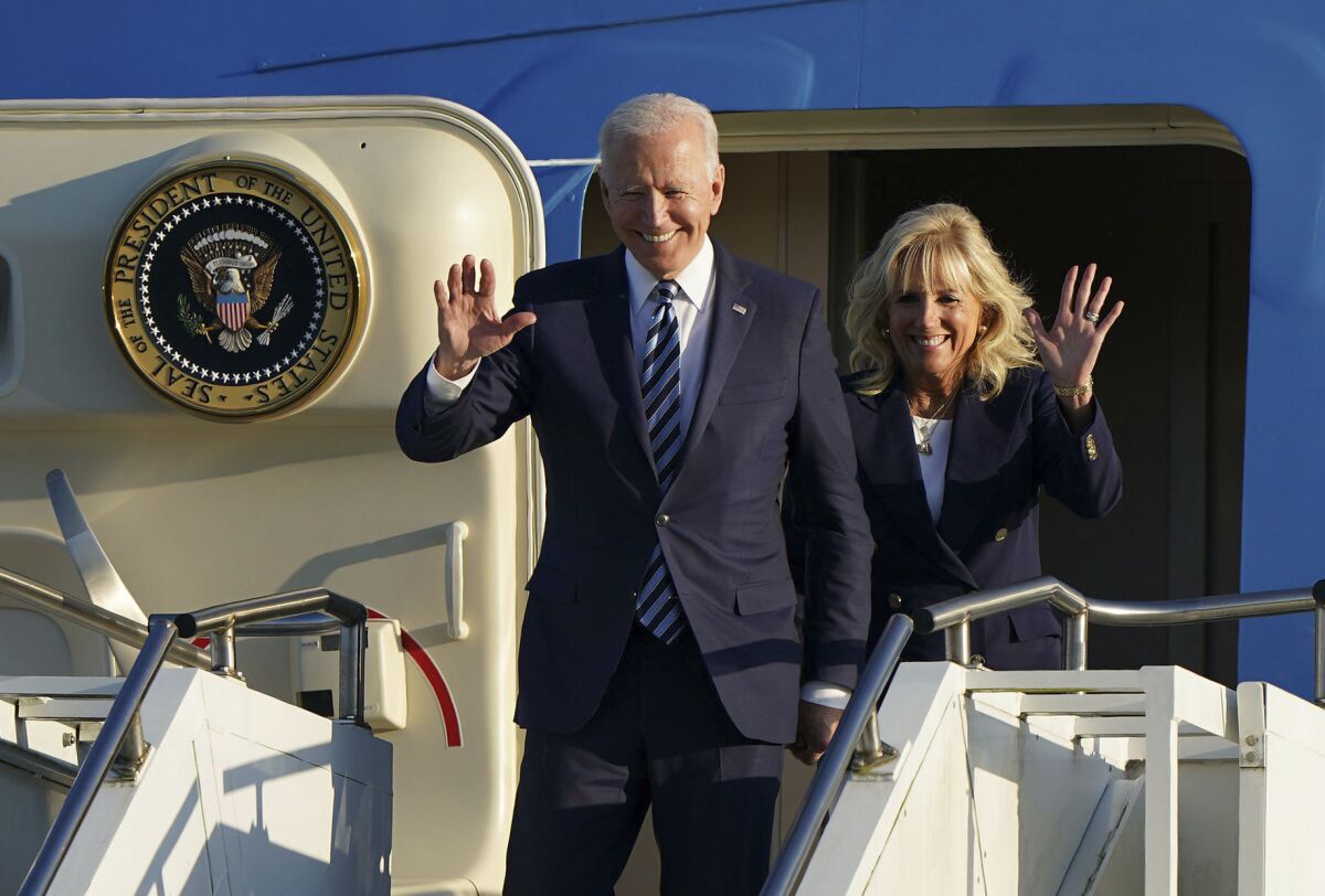 President Biden and First Lady Jill Biden walking off of a plane 