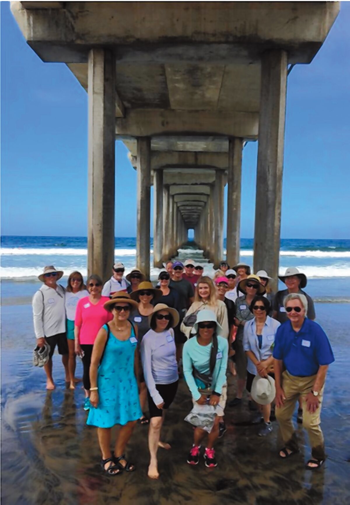 La Jolla Newcomers Club members pose under the iconic Scripps Pier.