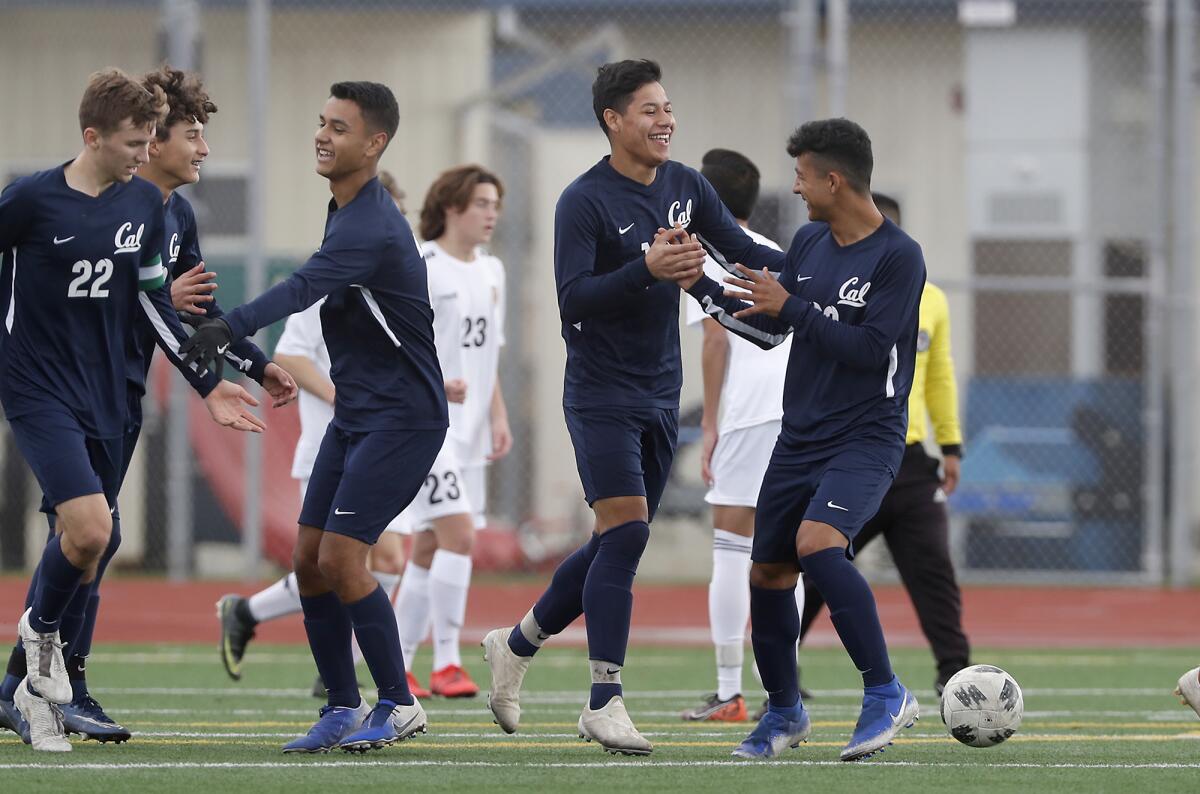 Whittier California's Jaime Lopez, far right, congratulates teammate Jose Luis Mariscal on his goal scored against Marina during the first half in a pool play match of the 33rd Annual Marina Holiday Classic on Thursday.