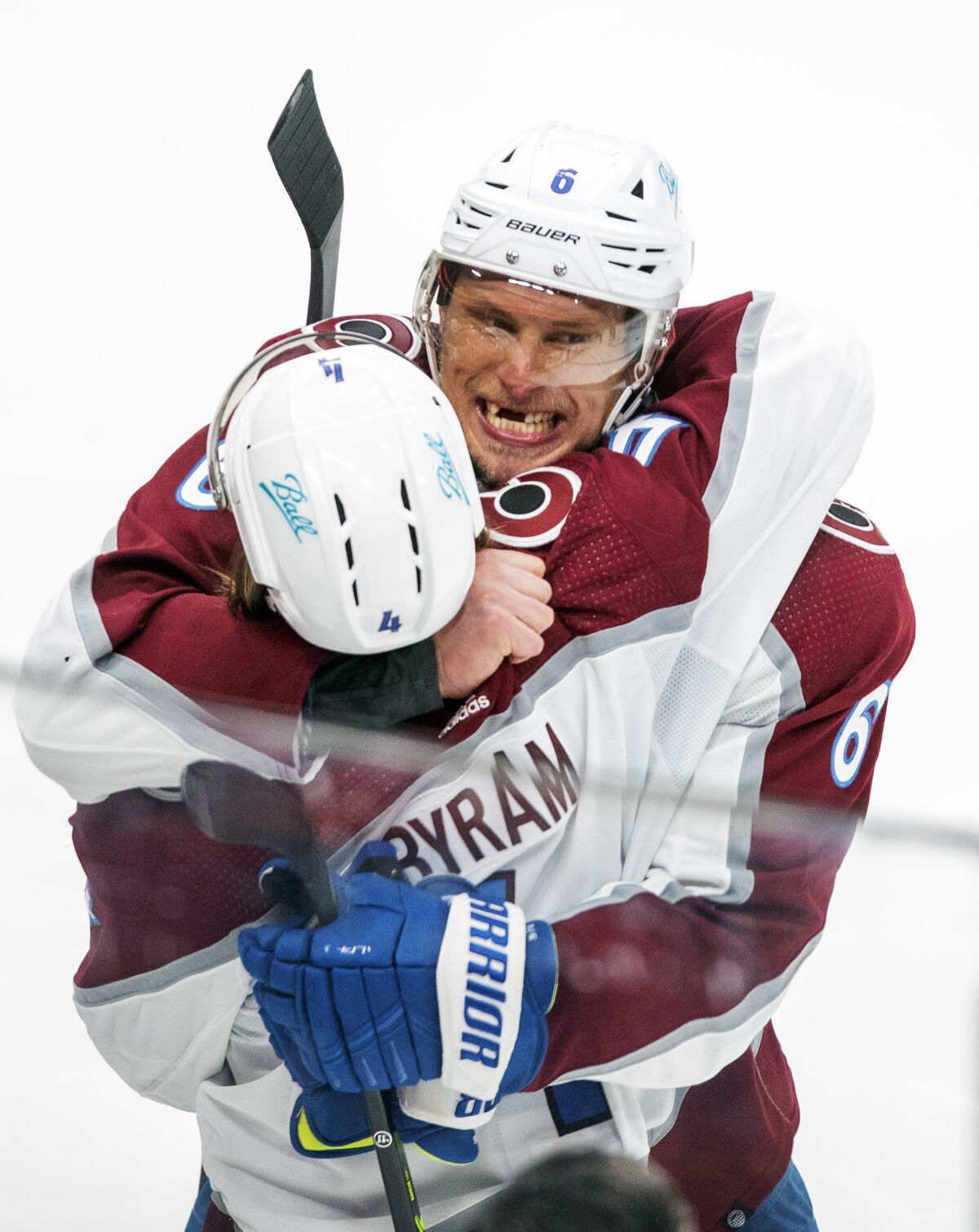 Colorado Avalanche's Erik Johnson (6) hugs Bowen Byram (4) after the team beat the Edmonton Oilers in overtime of NHL playoff hockey action in Edmonton, Alberta, Monday, June 6, 2022. The Avalanche won the game 6-5, to take the series. (Amber Bracken/The Canadian Press via AP)