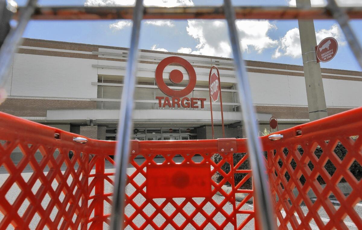 On top of the costs from last year's data breach, Target wrestled with weak U.S. sales in its second fiscal quarter.