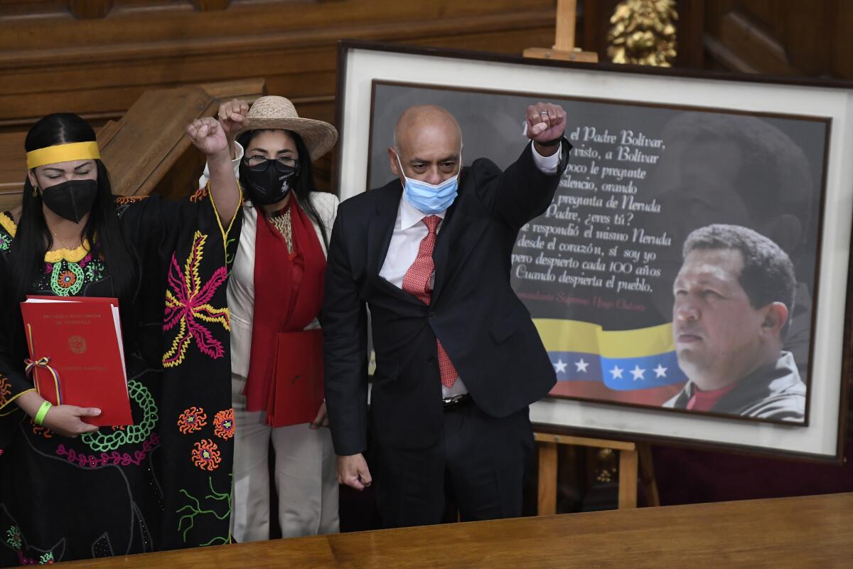 Jorge Rodriguez, right, lifts his fist after being sworn in as president of Venezuela's National Assembly 