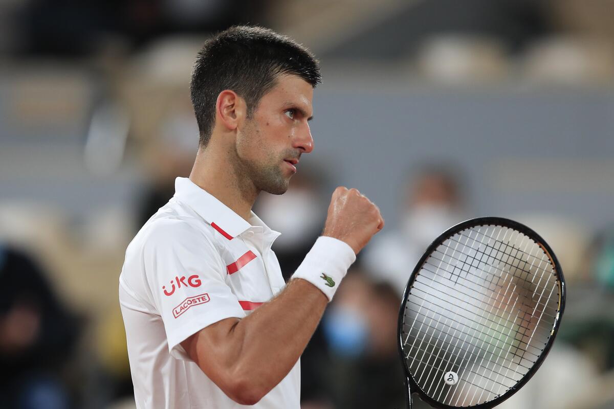 Novak Djokovic clenches his fist after scoring a point against Mikael Ymer.