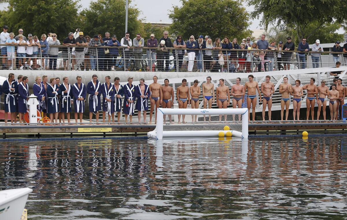 Members of the Newport Harbor and Corona del Mar boys' water polo teams, from left, are introduced on Thursday.