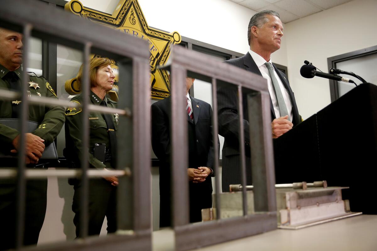 Robert Beaver, senior director at the Orange County Sheriff's Department, is shown with an improved plumbing wall vent at left. With him are Assistant Sheriff Steve Kea, left, and Sheriff Sandra Hutchens.