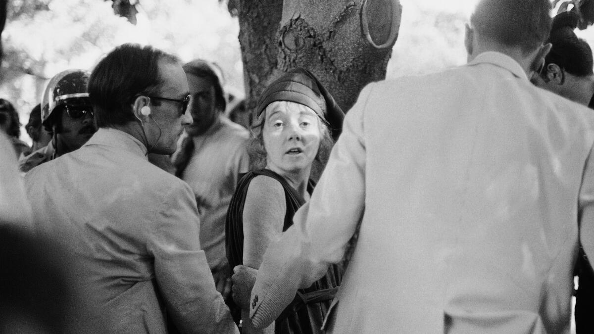 Secret Service agents lead Lynette "Squeaky" Fromme away after she pointed a gun at President Gerald Ford in Sacramento in 1975. (Associated Press)
