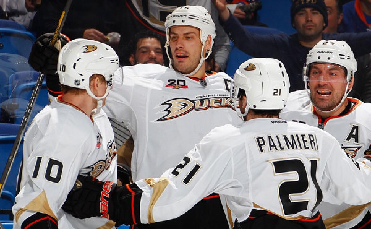 Ducks captain Ryan Getzlaf, center, celebrates with teammates Corey Perry, left, Kyle Palmieri, second right, and Francois Beauchemin after scoring against the New York Islanders in December. Getzlaf missed Sunday's win over the Detroit Red Wings because of an injury.