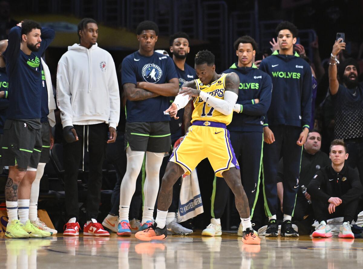 Lakers guard Dennis Schroder strikes the “freeze” pose in front of the Timberwolves bench.