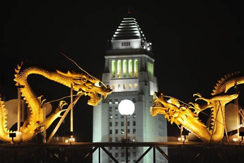 Twin dragons welcome visitors to Chinatown. In the background is Los Angeles' iconic City Hall.