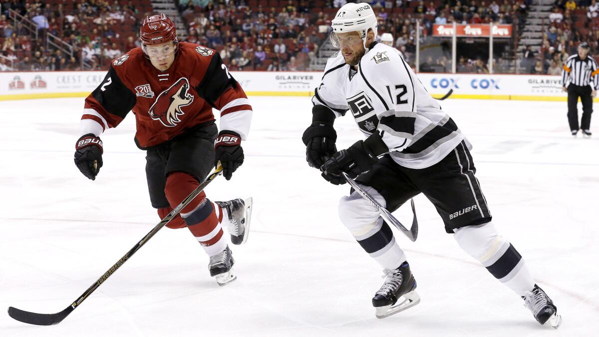 Marian Gaborik (12) chases after a puck alongside Coyotes defenseman Luke Schenn during their game Thursday.