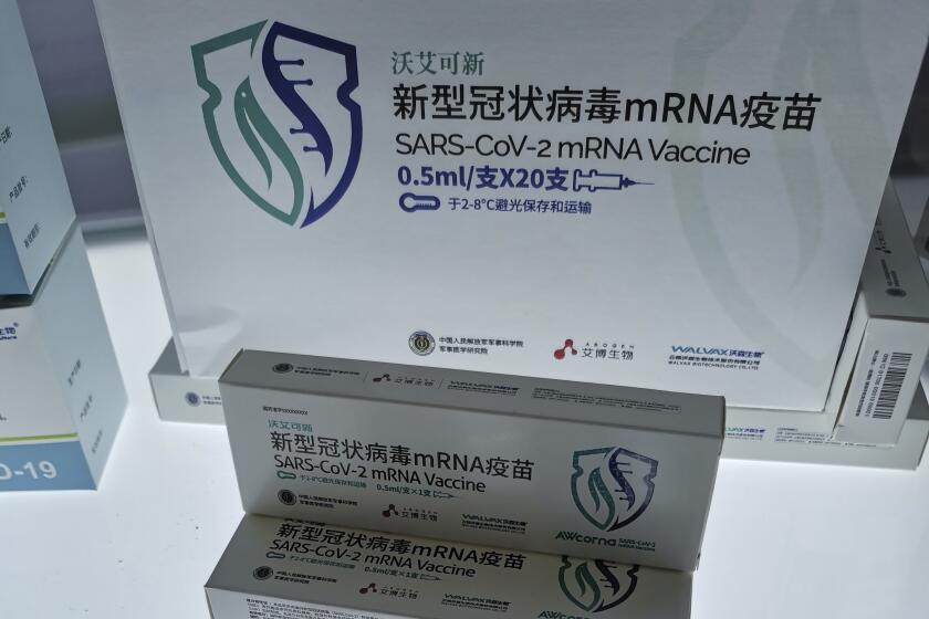China's first SARS-CoV-2 mRNA vaccine AWcorna, developed by Abogen Biosciences, Walvax Biotechnology, and the Academy of Military Medical Sciences' Institute of Biotechnology, is displayed at the National 13th Five-Year Scientific and Technological Innovation Achievement Exhibition in Beijing, China on Oct. 27, 2021. More than two years into the pandemic, China has not approved the more effective mRNA vaccines, instead choosing to pursue its own route on COVID-19 vaccines. (Chinatopix via AP)