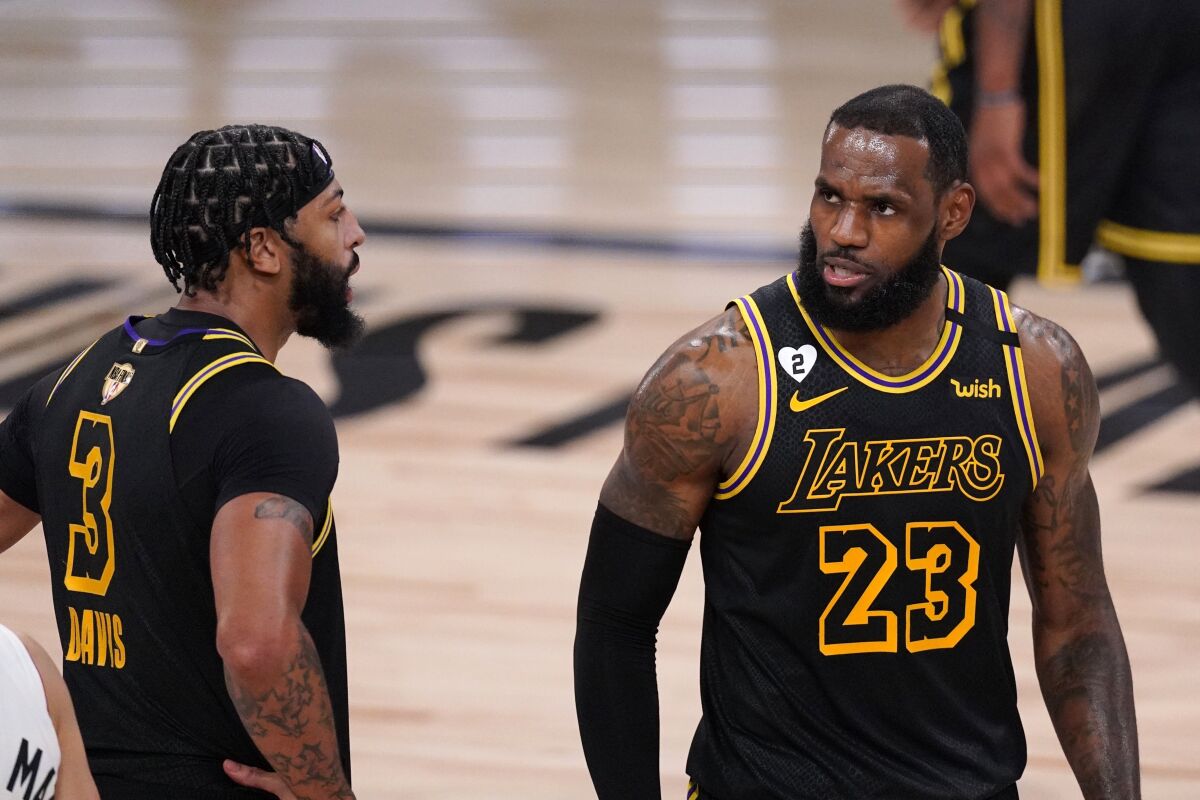 Lakers forwards Anthony Davis and LeBron James (23) talk strategy during Game 2.