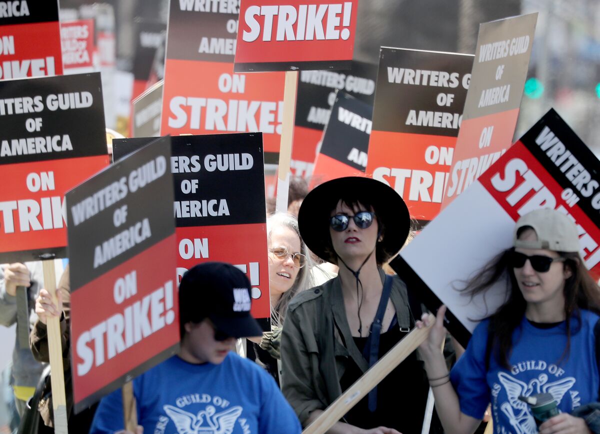 Striking Writers Guild of America workers picket outside the Sunset Bronson Studios in Los Angeles.