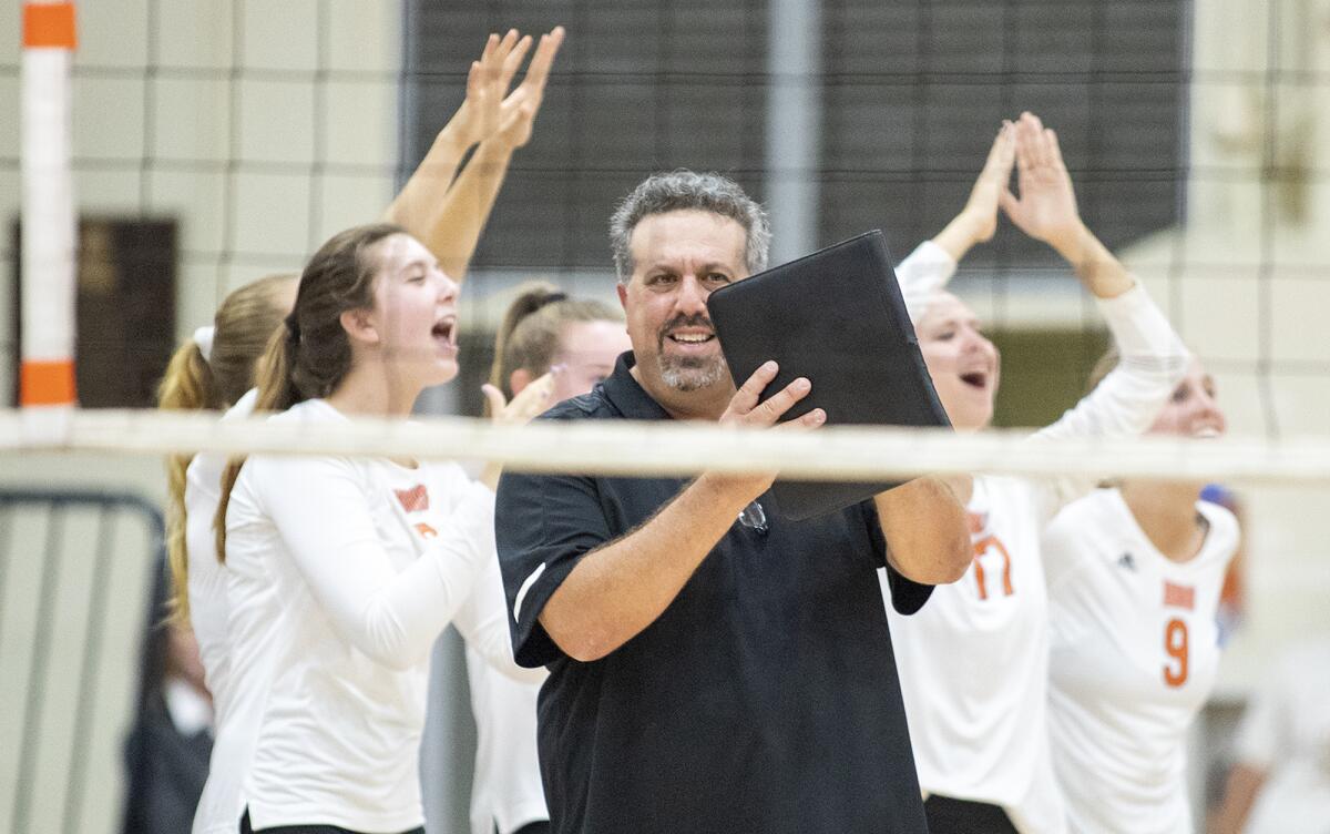 Huntington Beach head coach Craig Pazanti smiles after his team won a point against Edison during a Surf League match at home Thursday.