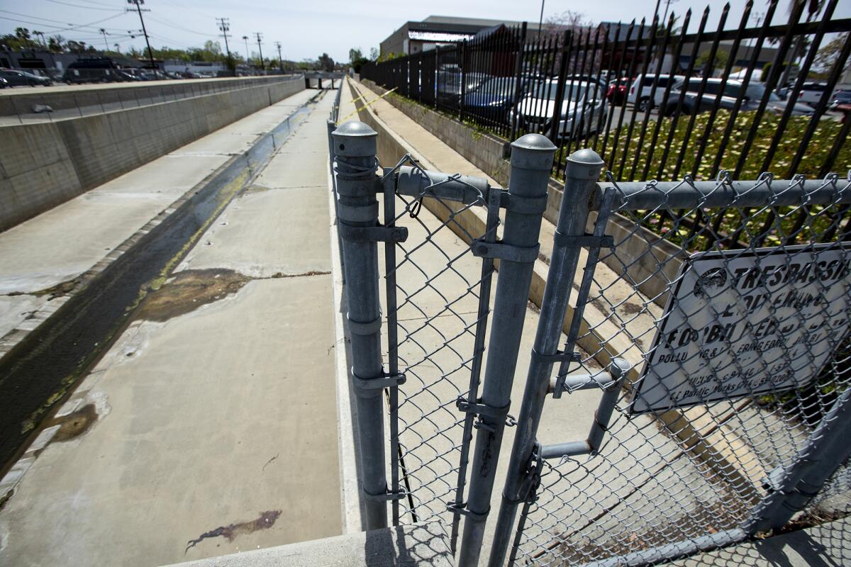 A flood control overpass on Paularino Avenue is the site where a man jumped or fell some 15-20 feet onto the concrete below.