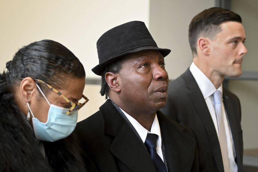 FILE - Anthony Broadwater, center, gazes upward, Nov. 22, 2021, in Syracuse, N.Y., after Judge Gordon Cuffy overturned the 40-year-old rape conviction that wrongfully put him in state prison for Alice Sebold's rape. Broadwater, who spent 16 years in prison, has settled a lawsuit against New York state for $5.5 million, his lawyers said Monday, March 27, 2023. (Katrina Tulloch/The Post-Standard via AP, File)