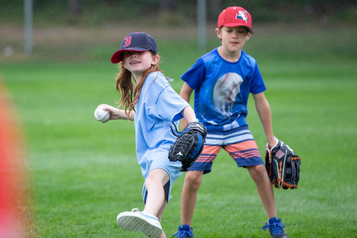 Two kids taking part in a youth clinic run by the Y-D Red Sox.
